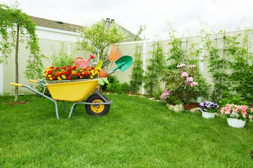 Front view of a residential garden with gardening tools and plants